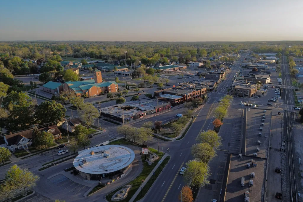 Aerial view of downtown Grandville, MI streets, shops and tree-lined blocks